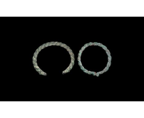 1st millennium BC. A pair of armlets, one formed from three twisted rods with T-shaped finials, one formed from two rods with