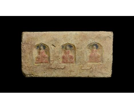 Northern Wei Dynasty, 386-535 AD. A ceramic rectangular brick with three niches with pointed arches; within each a seated fig
