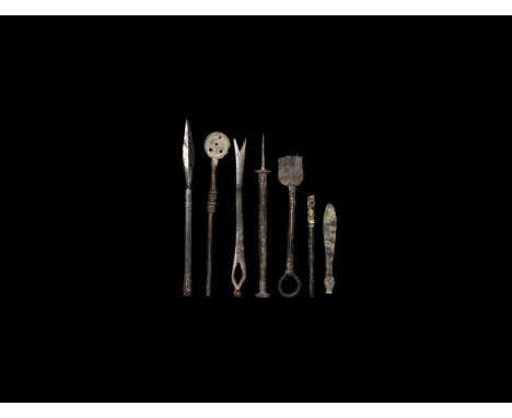 1st-4th century AD. A group of bronze medical instruments consisting of two scalpels; a spoon with holes in the dish and balu