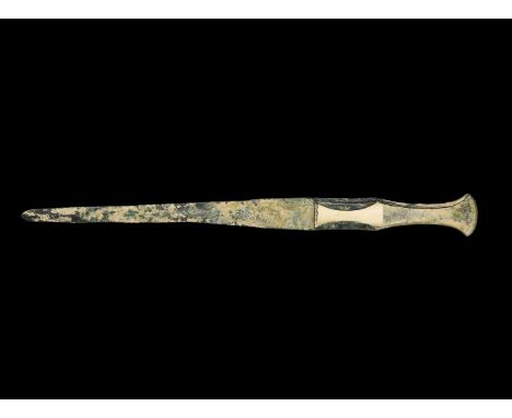 2nd millennium BC. A large bronze dagger with lozenge-section tapering blade, flat-section ricasso, lower guard with lateral 