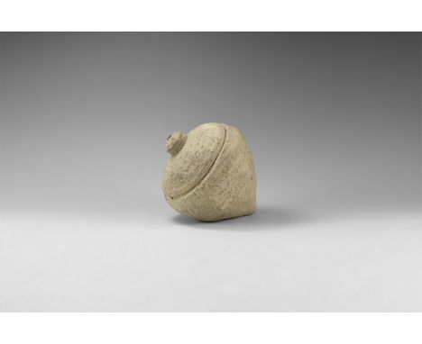 9th-11th century AD. A hollow ceramic vessel, piriform in profile; incised line above the point, the wide circular rim enclos