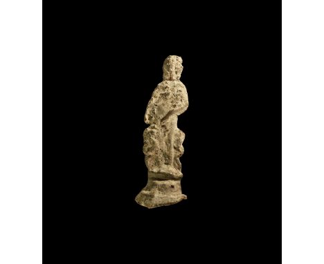 1st century BC-2nd century AD. A lead-alloy votive figurine of Venus (Aphrodite) standing on a tiered base holding her robe a