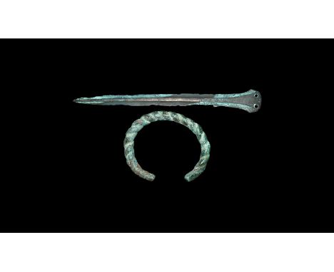 1st millennium BC. A group of bronze items comprising of a penannular bracelet formed from a single twisted rod and a long da