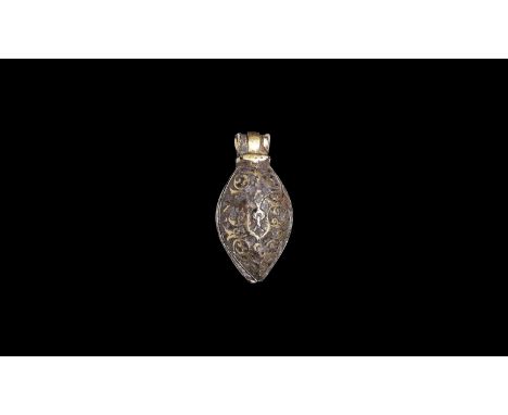 10th century AD. A silver-gilt two part, teardrop-shaped pendant with hinge to the top; scrolling floral decoration to both h