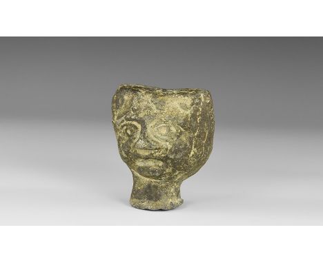 1st millennium AD. A hollow-formed lead-alloy finial, heart-shaped with a grotesque mask to each broad face, flared neck.   9