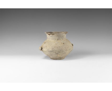 3rd millennium BC. A ceramic greyware biconical jar with broad neck and everted rim, two loop handles to the equator.   677 g
