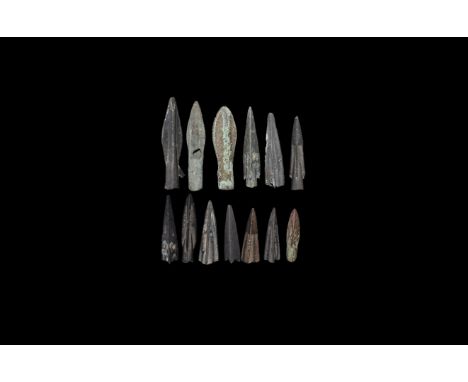 4th century BC. A group of eleven bronze triangular-section socketted arrowheads, two leaf-shaped socketted arrowheads.   35 