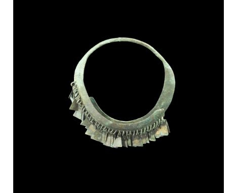11th-12th century AD. A neck-ring comprising a round-section bar extending to two overlapping arched plates, the front one pi