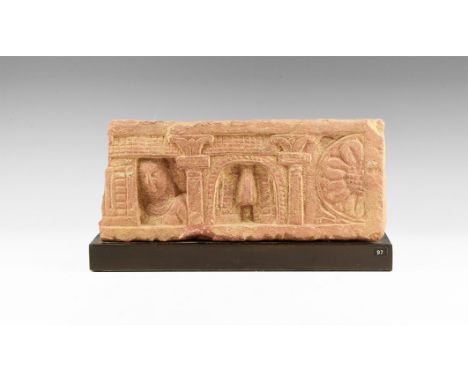 Gupta Period, 320-550 AD. A sandstone architectural panel carved with three niches separated by columns with floral tops; cen