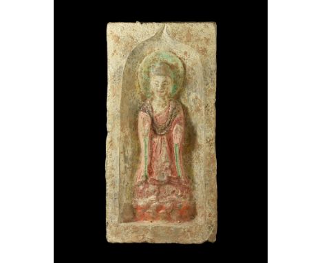 Northern Wei Dynasty, 386-535 AD. A ceramic rectangular brick with pointed arch recess; within the figure of Buddha standing 