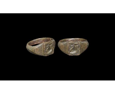 3rd-5th century AD. A bronze ring with angled shoulder, widening to a square bezel engraved with image of a standing bird wit
