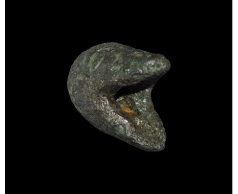 1st century BC-1st century AD. A bronze pommel comprising; a beast head with open mouth, almond-shaped eyes and incised line 