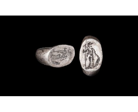 2nd century AD. A flat-section silver hoop expanding to convex shoulders, discoid plaque with intaglio image of Mars standing
