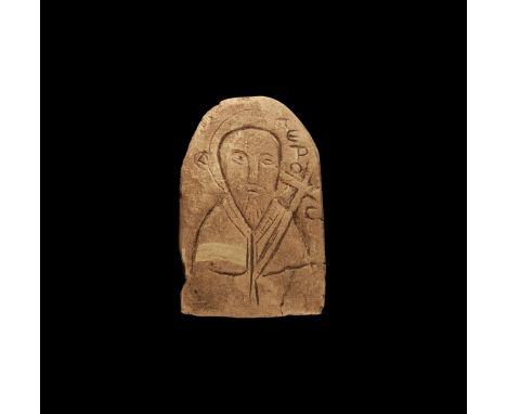 14th-15th century AD. A tongue-shaped limestone plaque with low relief facing image of St. Peter with beard and nimbus, cross