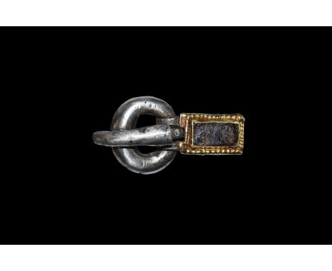5th century AD. A silver buckle comprising a substantial round-section loop, a tapering round-section tongue with curved forw