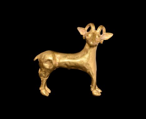 Early 1st millennium BC. A gold figure of a standing male antelope, head turned to the right, horns curving round ears; legs 