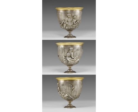 20th century AD. A silver cup with deep bowl on an ornamented stem with repoussé decoration to the outer face depicting two m