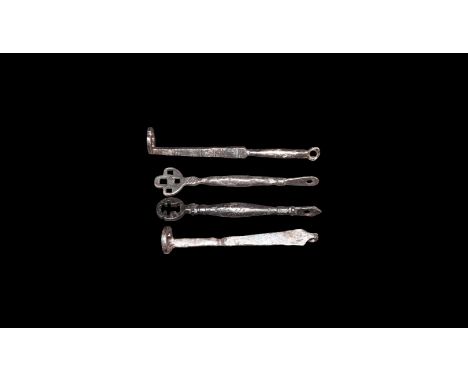 9th-11th century AD. A mixed group of iron keys comprising: two with balustered shaft, pierced flange, voided head; one simil