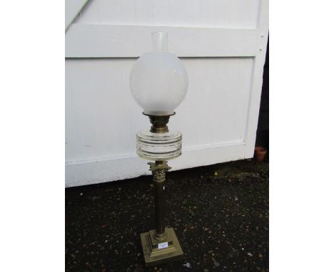 Oil lamp with  white globe shade and brass base
