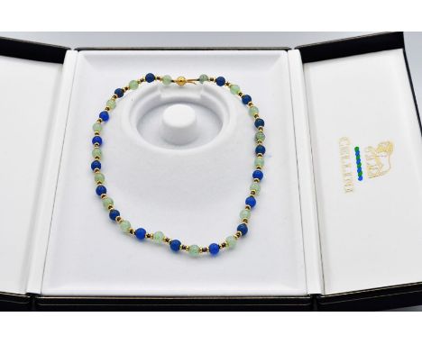 Lapis and opal beads, interspersed with eighteen carat gold rondelles and finished with an eighteen carat gold fancy bolt cla