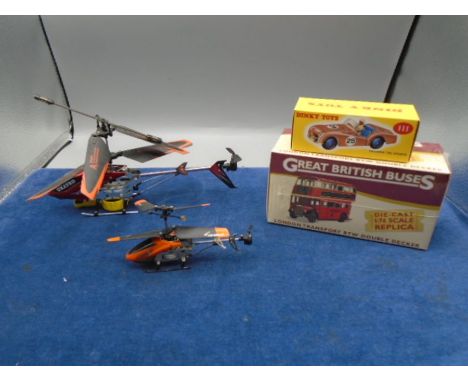 2 remote controlled helicopters with leads, instructions and spare blades, a boxed London bus and a Triumph Dinky toy