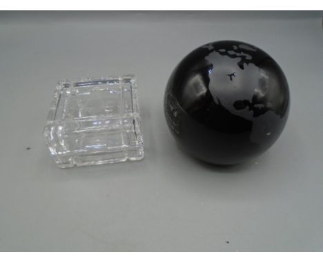 A glass globe paperweight and a glass trinket pot