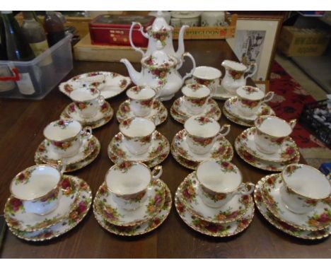 Royal Albert 'country roses' tea set comprising 12 cups, saucers and cake plates, a round cake plate, oval server plate, tea 