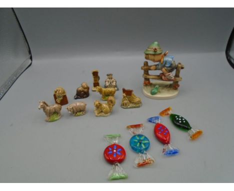 A Goebel figure of a boy on a fence, a collection of Wade whimsies and 4 Italian glass sweets