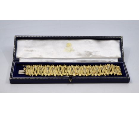 An 18ct. gold bracelet, London 1973, fashioned from sections of textured bars with bead ends, width 3.3cm x length 18.5cm. (1