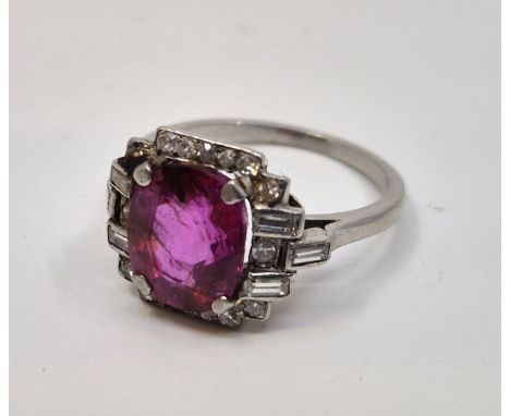 An early 20th century white metal, ruby and diamond ring, set cushion cut ruby to centre (approx. 9mm x 7.5mm x 4.5mm, approx