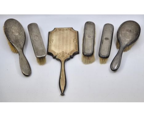 A collection of six silver mounted dressing set items, to include: a silver and light brown guilloche enamel mounted table mi