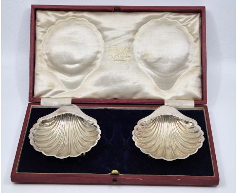 A pair of silver scallop shell form butter dishes, by Harrison Brothers & Howson, Sheffield 1911, each raised upon triple bal