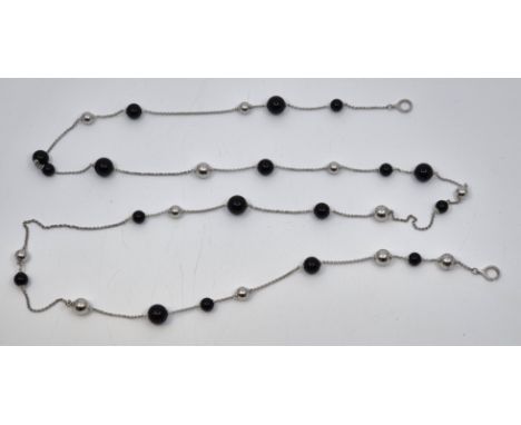 A Georg Jensen sterling silver and black onyx bead necklace, set at random stations with graduated silver and black onyx sphe