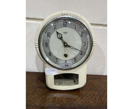 A 1930s metal enamel cased Smiths kitchen wall clock. 10" high