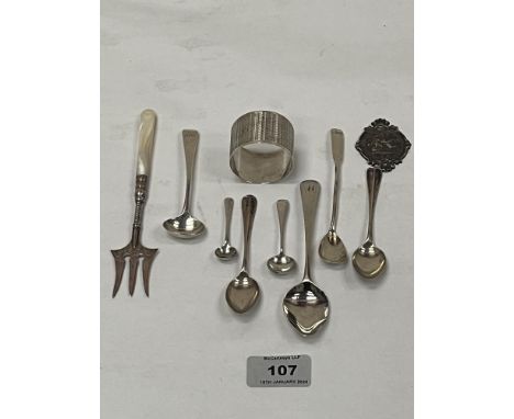 A collection of silver sppons; napkin ring; a silver pickle fork; a white metal St. Christopher and a white metal mustard spo