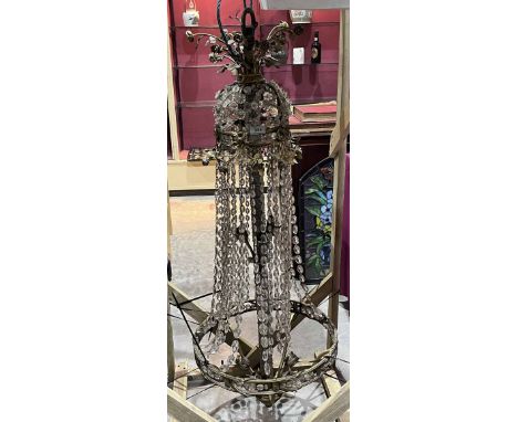 A gilt metal chandelier of ten lights hung with pendant drops. Partially dismantled. 48" high.