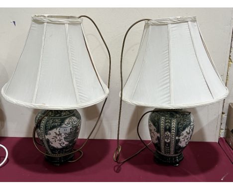 A pair of ceramic based table lamps.