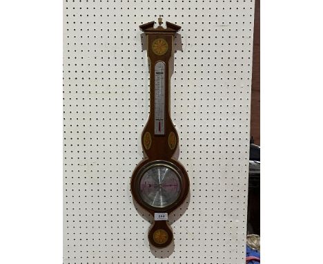 An aneroid barometer by O. Comitti and Son with inlaid mahogany case. 26" high