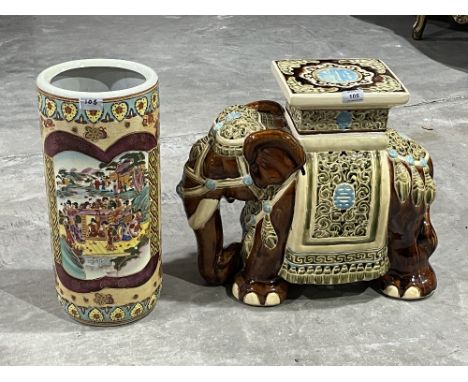 An oriental style glazed ceramic elephant garden seat, 17" high; together with a stick stand.