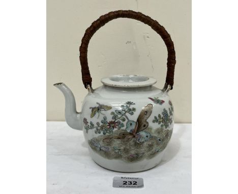 A Chinese porcelain teapot and cover, decorated with foliage and flying insects to one side and swallows to the other. Seal m