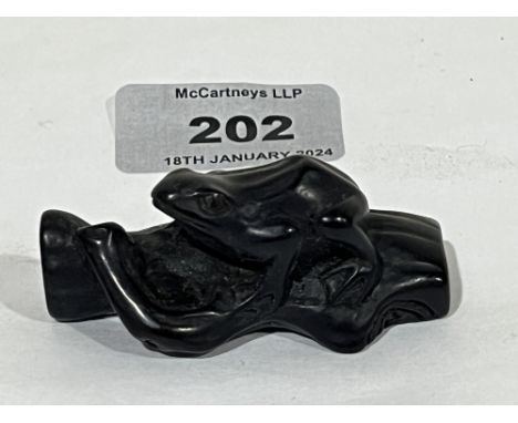A Japanese hardwood netsuke, carved as a frog on a log. 2¼"  long. Meiji.