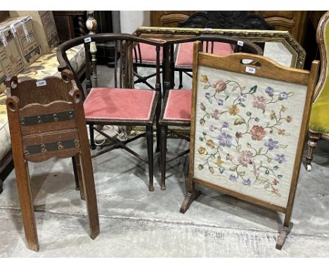 A pair of Edwardian corner chairs; an needlework fire screen; an oak jardiniere stand; an onyx lamp standard and a gilt frame