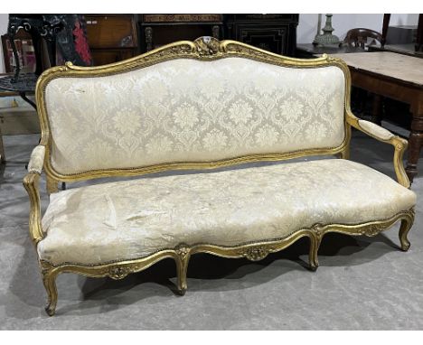 An early 20th century giltwood sofa in the French taste, with open arms, on cabriole legs. 75" wide.