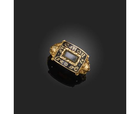 A George III gold and enamel mourning ring, circa 1808, centring on a glazed panel of hairwork, within a rectangular black en