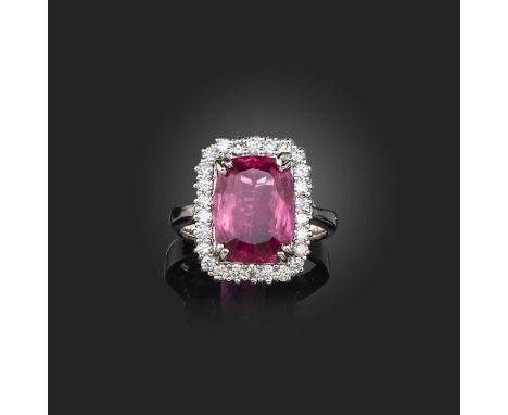 A pink tourmaline and diamond ring, set with a cushion-shaped pink tourmaline, within a border of brilliant-cut diamonds, mou