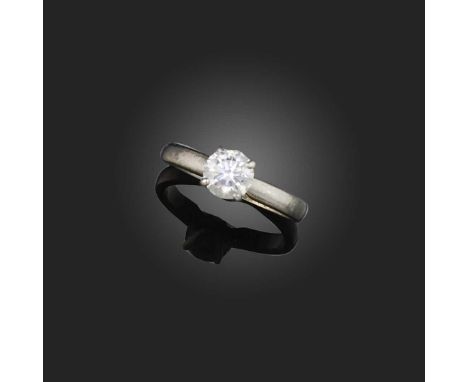 A diamond solitaire ring, claw-set with a brilliant-cut diamond weighing 0.77 carats, to a plain platinum band, size I1/2, Br