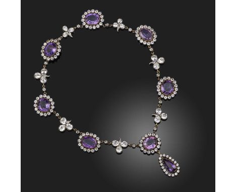 A George III amethyst and paste-set necklace, formed from oval amethyst and white paste clusters separated with paste trefoil