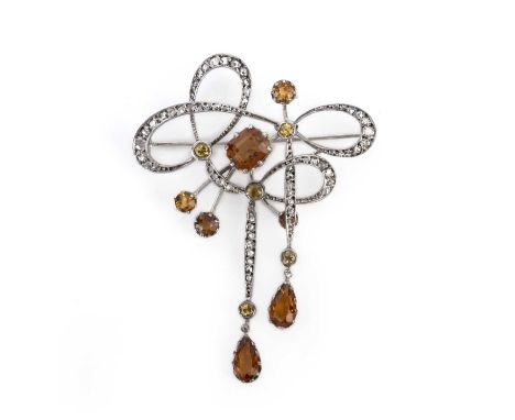 A citrine and diamond brooch, early 20th century, designed in the Art Nouveau style as an abstract ribbon bow suspending two 