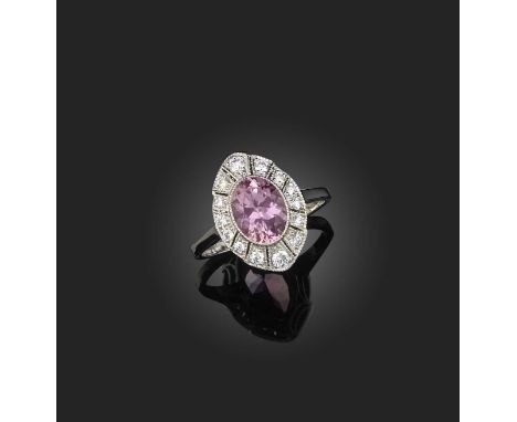 A pink tourmaline and diamond cluster ring, the cushion-shaped pink tourmaline weighing approximately 1.90 carats, in a surro