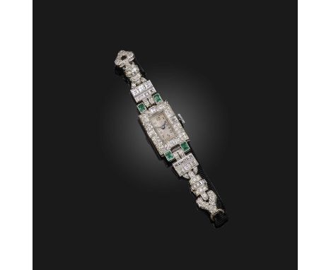 An Art Deco emerald and diamond wristwatch, the plain rectangular dial with Arabic numerals, the case set with four emeralds 